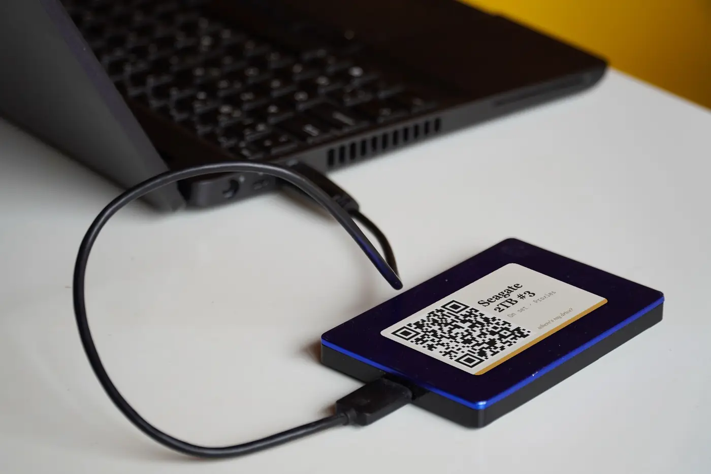 A QR-labelled drive plugged into a laptop